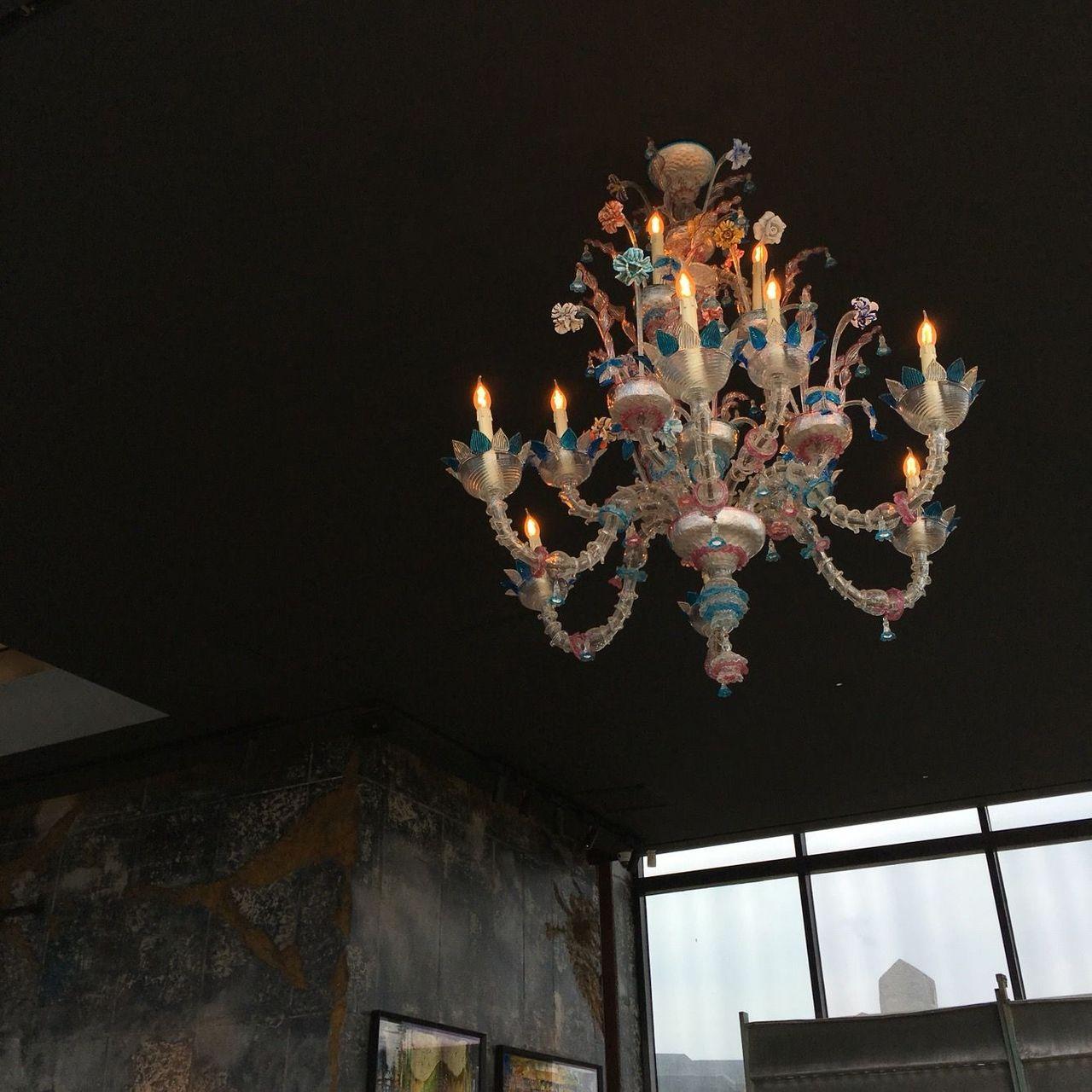 Interior of Café Mônsant in Jeju Island, with a beautiful, detailed chandelier hanging from the ceiling.